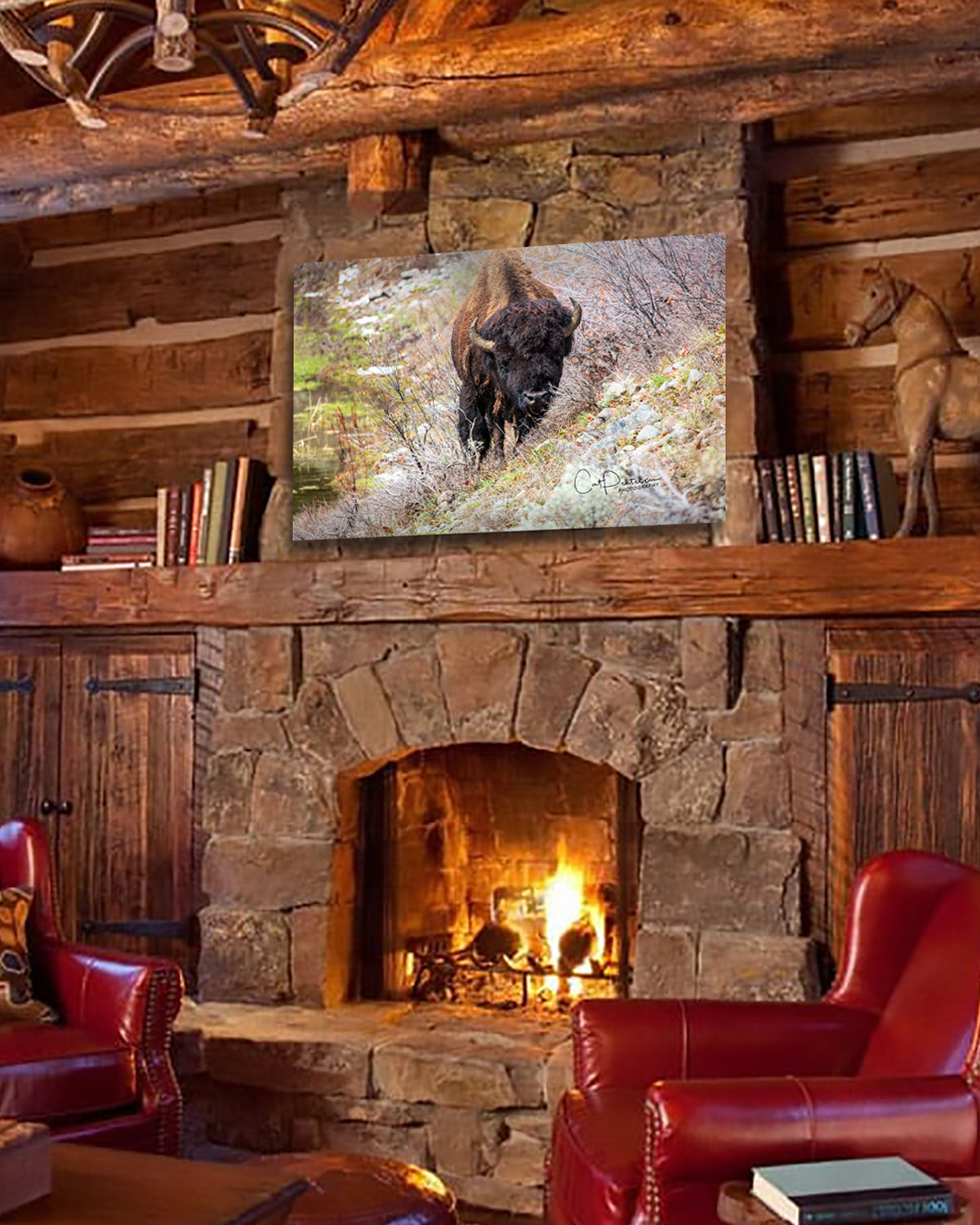 Wild bull buffalo bison coming out of the Marsh over stone fireplace mantel in log home